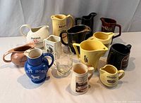 Group view showing all 14 whisky advertising pitchers