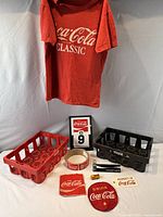 All items grouped: T-shirt, two crates, tape roll, calendar, sign