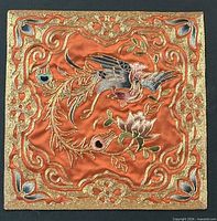 Close-up of embroidered silk panel showing phoenix and floral details