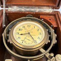 Dial and gimballed brass chronometer inside wooden case