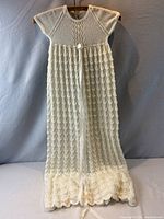 Full view of long crocheted christening gown