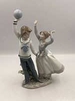 Front view of Lladro Children at Play figurine showing full pose