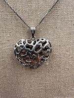 Close-up of openwork heart pendant on chain