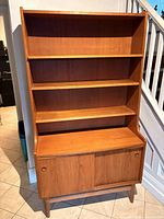 Front view showing shelves, cupboard doors and feet