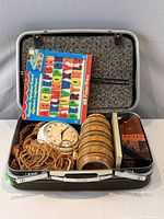 Open suitcase showing all vintage contents