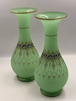 Front view of both green satin opaline vases