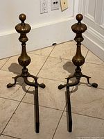Pair of brass andirons front view showing full structure and condition