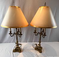 Pair of brass Rococo candelabra table lamps with shades front view