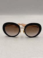 Front view of sunglasses showing frame shape and lens gradient