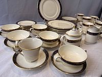 Overview of plates, cups, saucers, sugar bowl, creamer