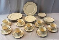 Full view of complete 44-piece Carolyn pattern dinnerware set arranged on table