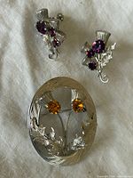 Brooch and earrings front view on fabric