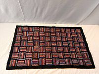 Full view of rectangular hooked rug showing overall pattern