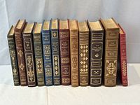 Front view of all 12 leather-bound volumes standing upright