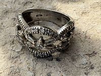 Front angled view of white gold diamond ring showing marquise, baguette and round diamonds