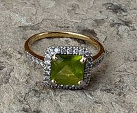 Front view showing peridot, diamond halo, and shoulders