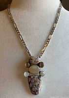 Front view of necklace on bust form showing chain style and pendant design