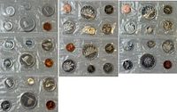 Front view showing multiple sealed coin sets laid out
