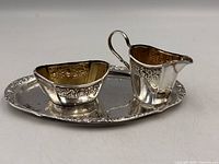 Creamer and sugar bowl on oval tray, front angle