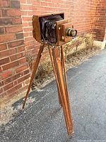 Full view of camera mounted on wooden tripod