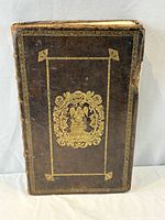 Front cover showing gilt central panel and border