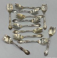 All 12 sterling pierced forks laid out to show quantity, pattern and general condition