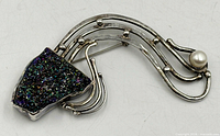 Full view of sterling silver brooch showing druzy stone, pearl and flowing design