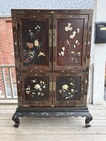 Full frontal view of cabinet showing doors, inlay, base