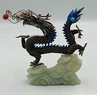 Full view of enameled sterling silver dragon on carved jade base