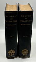 Spine view of both volumes showing gilt titles and Oxford crest