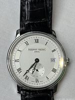 Front close-up of watch showing dial, case, and strap attachment