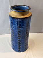 Front view of blue textured stoneware floor vase