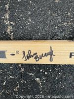 Close-up of John Bucyk autograph on stick shaft