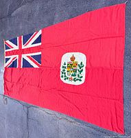 Full view of Canadian Red Ensign flag laid flat showing design and proportions