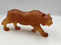 full side view of amber glass tiger sculpture