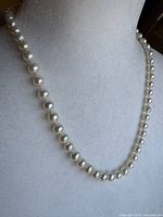 Full view of pearl necklace on display bust