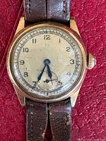 Front view of Omega wristwatch showing dial, hands, case and strap