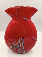 Full view of red Murano glass vase front, showing millefiori section and flared rim.