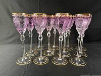 Front view showing all 12 goblets, amethyst bowls, gilt rims, clear stems and feet
