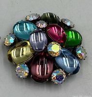 Front view of brooch showing multicolour cabochons and AB rhinestones