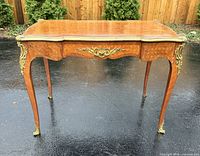 Full view of desk front with ormolu mounts and cabriole legs