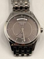 Front view of watch showing dial, bracelet, and brand markings