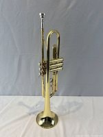Full view of Yamaha YTR-233 trumpet standing with mouthpiece attached