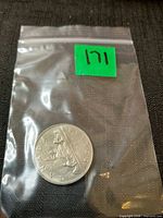 coin in resealable bag with lot sticker visible