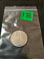 Coin in plastic bag front showing Voyageur reverse