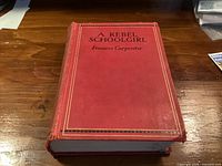 Front cover of red cloth hardcover showing title and wear