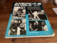 Front cover of America In Wax book showing title, author, subtitle noting 678 illustrations