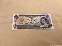 Front of 1973 Canadian $1 banknote showing design and serial number