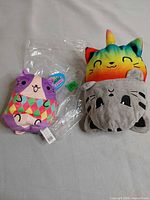 Both plush toys side by side on surface