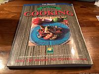 Front cover of Cottage Cooking cookbook showing title, author, subtitle, and cover art